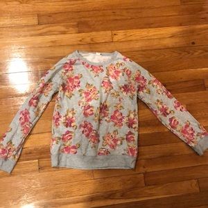 Long sleeve type sweatshirt that has pink flowers